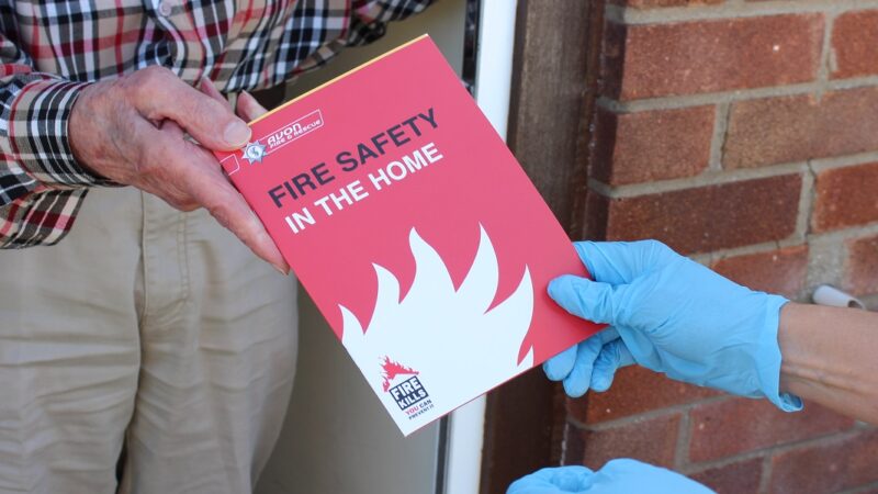 home fire safety booklet being handed over to resident