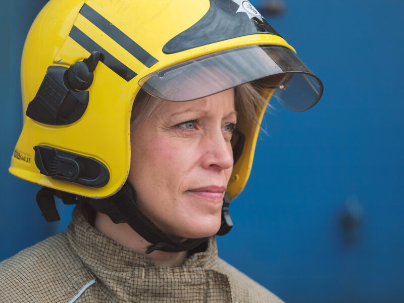 picture of a white female firefighter in full kit