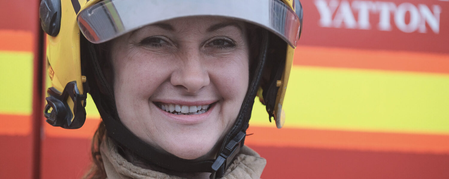 Female white firefighter in full kit