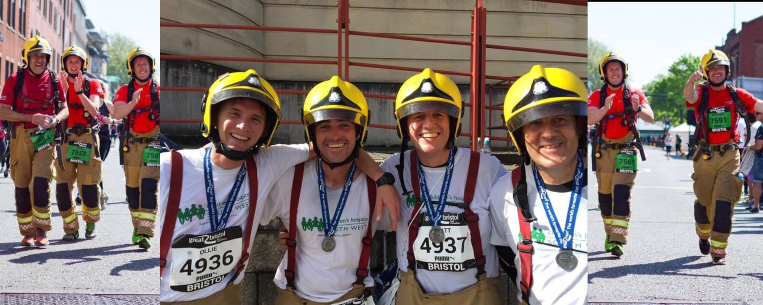 group of firefighters wearing fire helmets and smiling with great bristol run t-shirts and medals on.